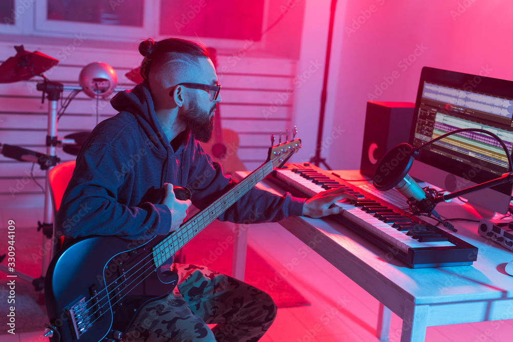 Create music and a recording studio concept - Bearded funny man guitarist  recording electric bass guitar track in home studio Stock Photo | Adobe  Stock