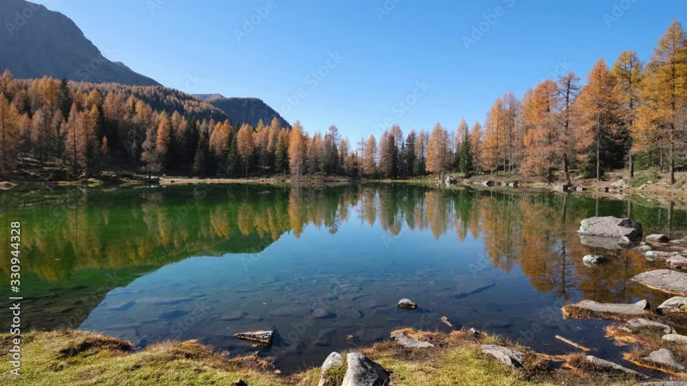 Autumn alpine mountain lake near San Pellegrino Pass, Trentino, Dolomites Alps, Italy. Picturesque traveling, seasonal and nature beauty concept scene. Autumn alpine mountain lake near San Pellegrino Pass, Trentino, Dolomites Alps, Italy. Picturesque traveling, seasonal and nature beauty concept scene.