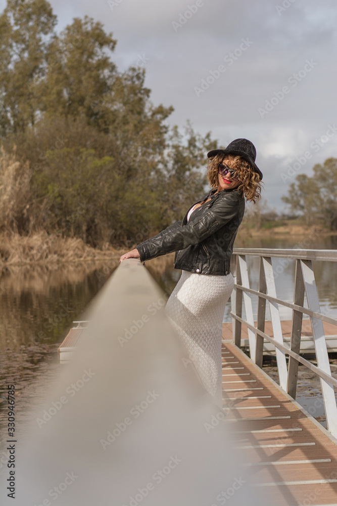 Model woman holding on to the railing of a jetty. Lifestyle Model woman holding on to the railing of a jetty. Lifestyle
