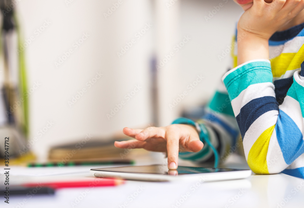 Child hand pointing on Digital tablet Child hand pointing on Digital tablet