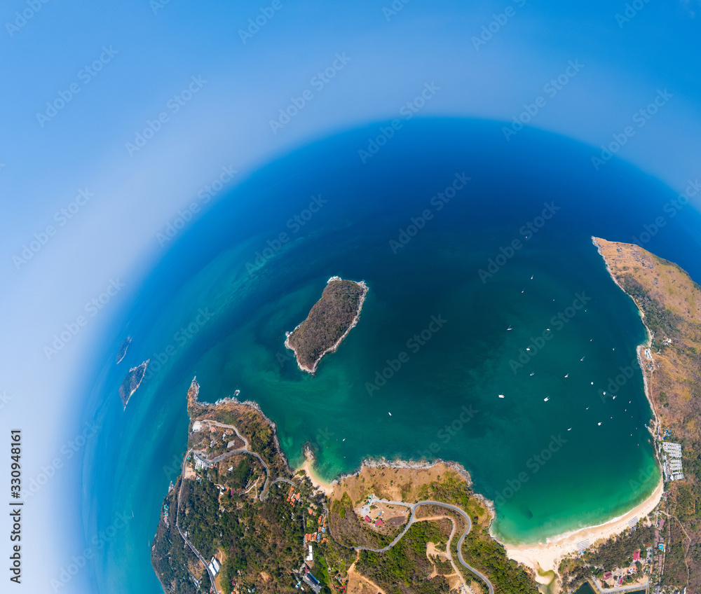 Aerial view of the coastline of Phuket island in the form of a little planet. Thailand