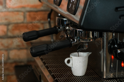 coffee machine pours a fresh batch of espresso