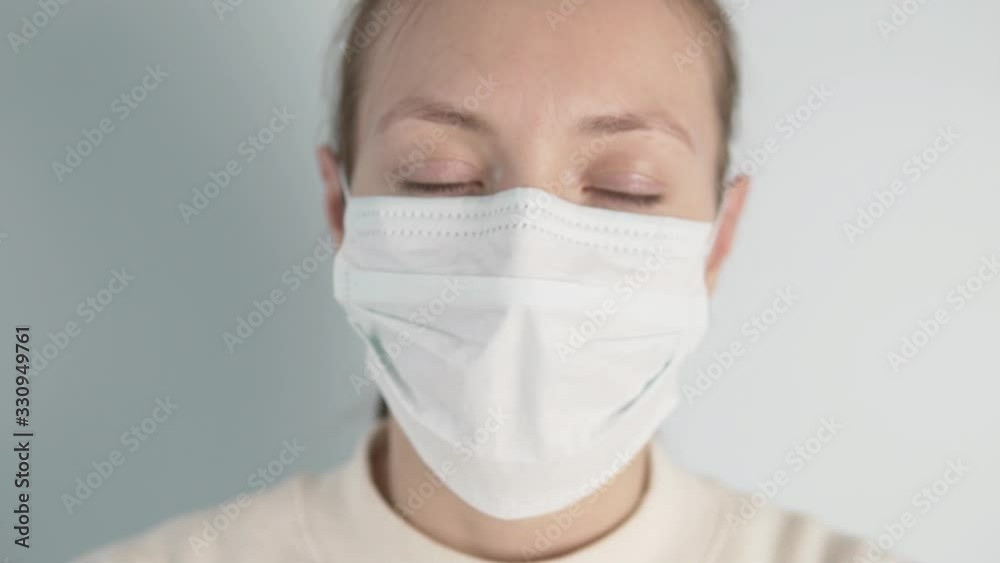 A woman in a protective medical mask with a virus . A woman in a protective medical mask with a virus .