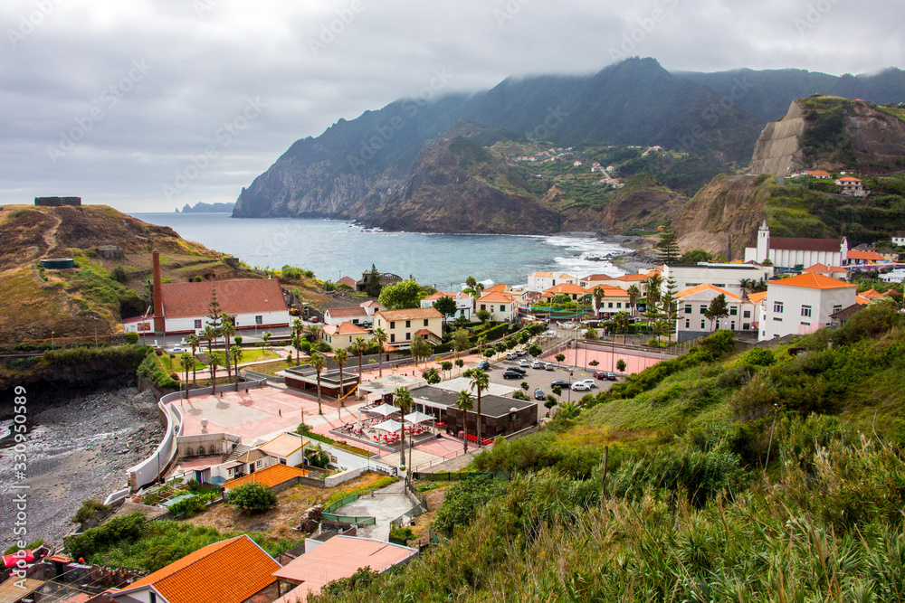 Dramatic coastal scenery of the village of Boaventura and the Arco de Sao Jorge mountain range on the north coast of the Portuguese Island of Madeira