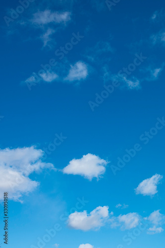 a group of white cirrus clouds in the blue sky as a natural background