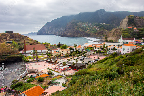 Dramatic coastal scenery of the village of Boaventura and the Arco de Sao Jorge mountain range on the north coast of the Portuguese Island of Madeira photo