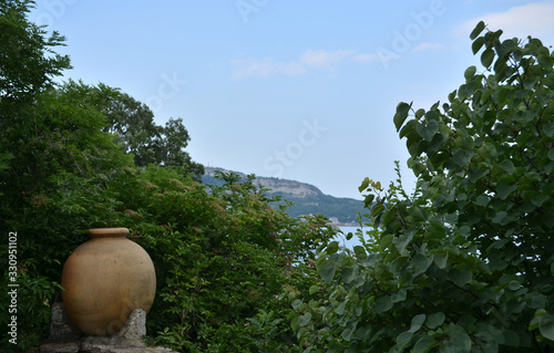 Mediterranean sea view with an old roman vase. photo