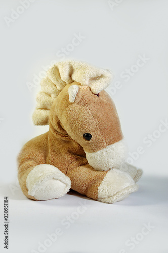 A beautiful pony mascot sitting alone and thoughtful. Waiting to hug him.