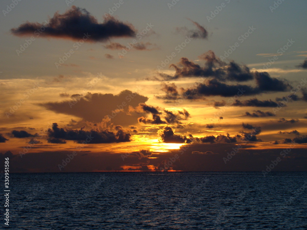 A beautiful and romantic sunset at the Maldives seen from a luxurious villa. Holidaying in Maldives without seeing a sunset is a bit like going to Paris without seeing the Eiffel Tower.