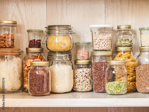 Canvastavla Shelf in the kitchen with various cereals and seeds - peas split, sunflower and