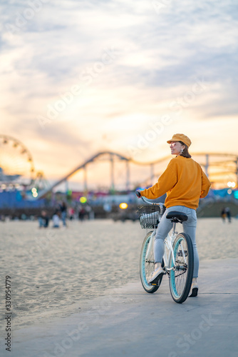 Attractive girl with a bike on Santa Monica