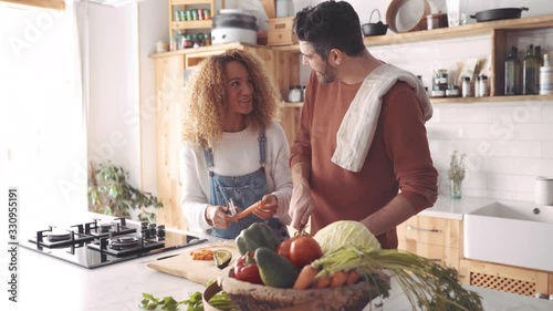 Couple preparing food in kitchen.