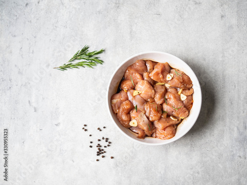 Quadro em tela Raw diet marinated turkey meat with garlic, ginger and teriyaki sauce in white bowl