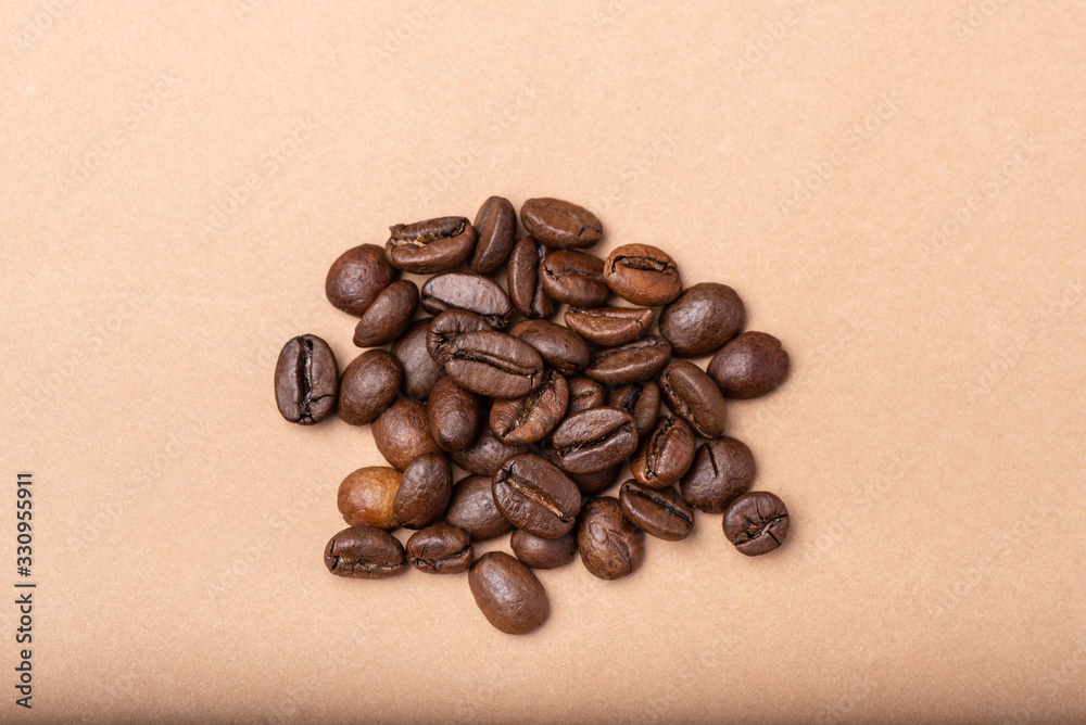 group of coffee beans on a brown background group of coffee beans on a brown background