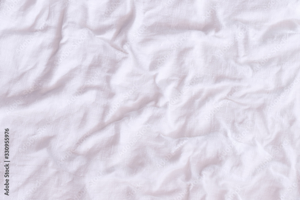 Rough crumpled white linen fabric background texture frontal view. Rough crumpled white linen fabric background texture frontal view.