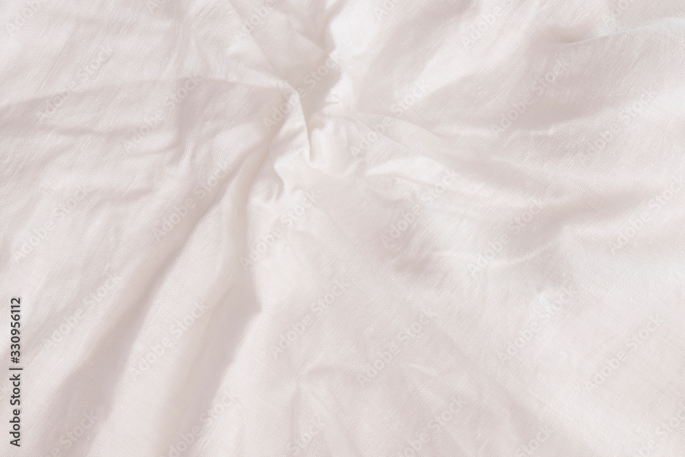 Rough crumpled white linen background texture close up frontal view.