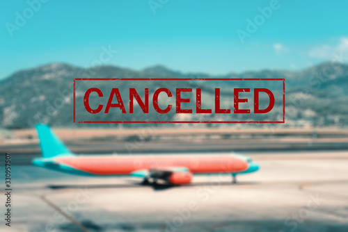 Airplane and flight cancellation. Canceled flights in Europe, Asia and USA airports. Travel cancelled. Pandemic of coronavirus. Background of passenger aircraft on runway at sunset and text. Covid-19
