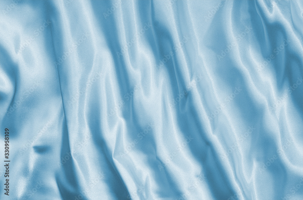 Naklejka premium Closeup of rippled light blue silk fabric lines