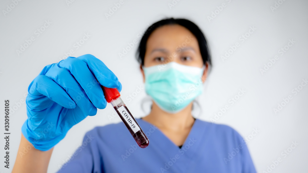 Doctor holding blodd in test tube for checking Covid-19
