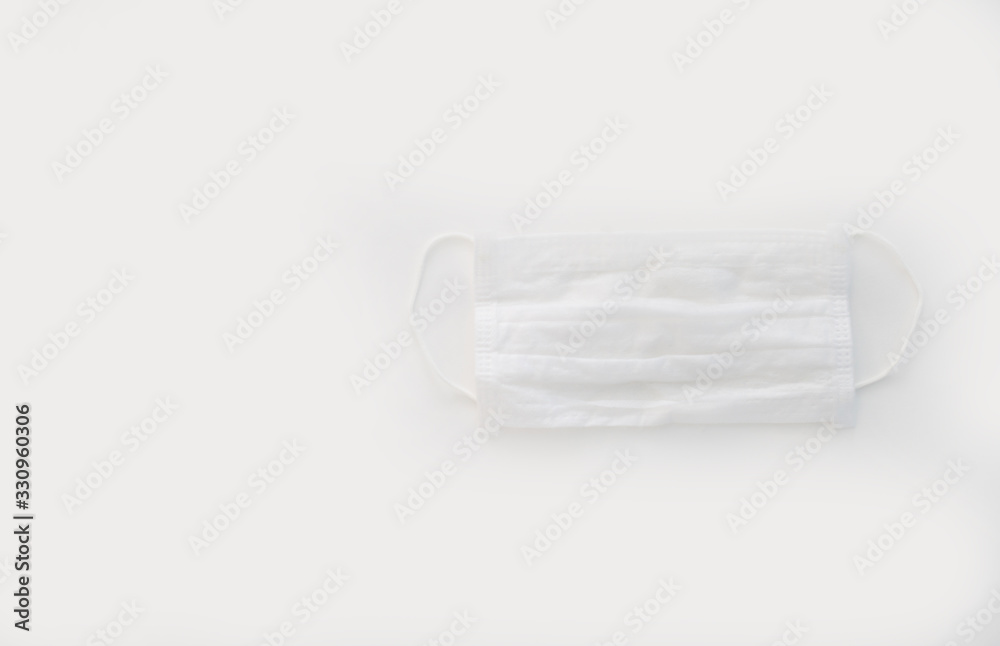 medical mask on a plain background with flowers medical mask on a plain background with flowers