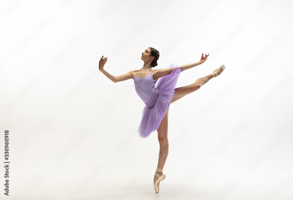 Graceful classic ballerina dancing, posing isolated on white studio background. Bright purple tutu. The grace, artist, movement, action and motion concept. Looks weightless, flexible. Fashion, style.