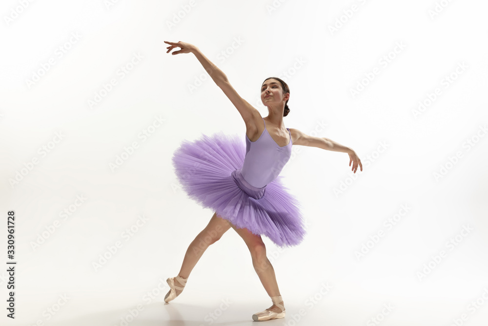 Graceful classic ballerina dancing, posing isolated on white studio background. Bright purple tutu. The grace, artist, movement, action and motion concept. Looks weightless, flexible. Fashion, style. Graceful classic ballerina dancing, posing isolated on white studio background. Bright purple tutu. The grace, artist, movement, action and motion concept. Looks weightless, flexible. Fashion, style.