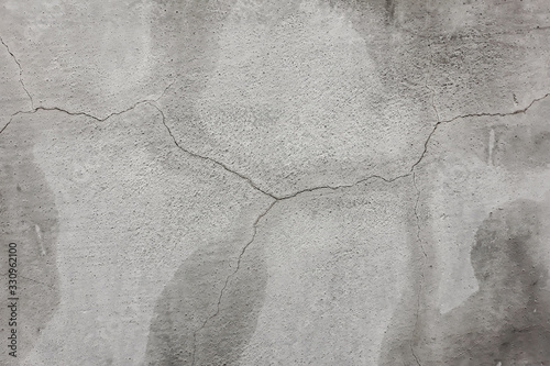 Plaster background. Cement wall texture with cracks. Old wall. Moisture is released through cracks in the cement wall.
