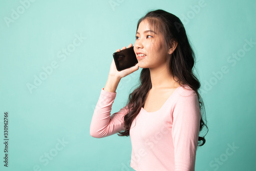 Young Asian woman talking with mobile phone.