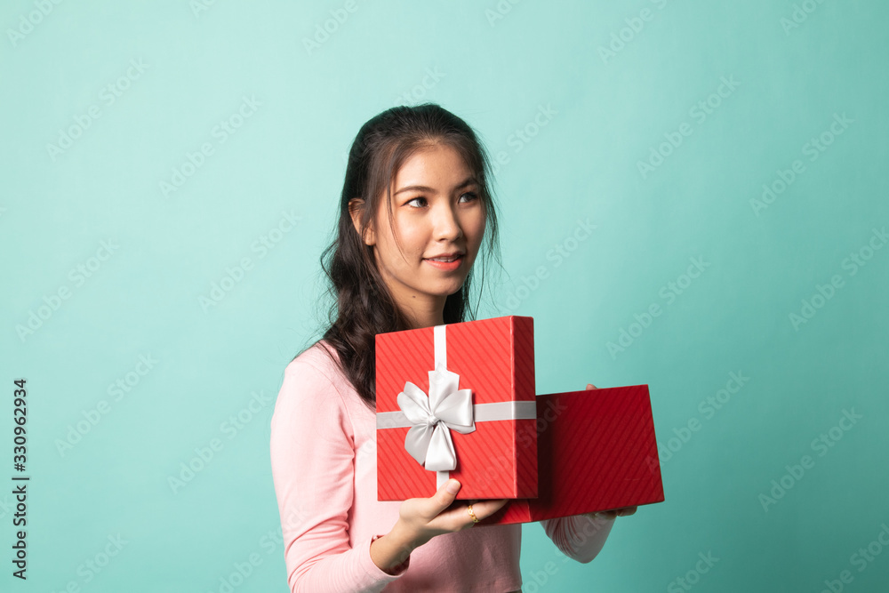 Young Asian woman open a gift box. Young Asian woman open a gift box.