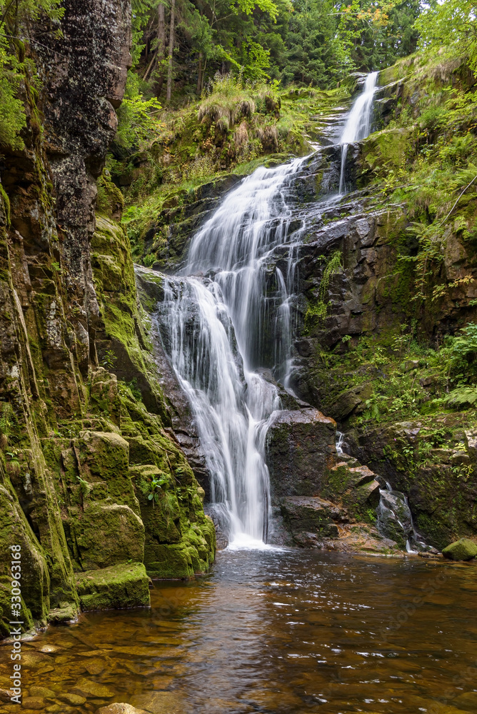 Fototapeta premium Blurred water of waterfall of Kamienczyk river in Poland