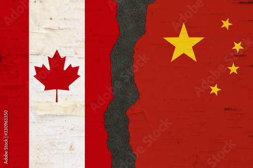 Photography Canadian and Chinese flags that are torn apart