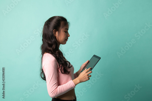 Young Asian woman with a computer tablet.