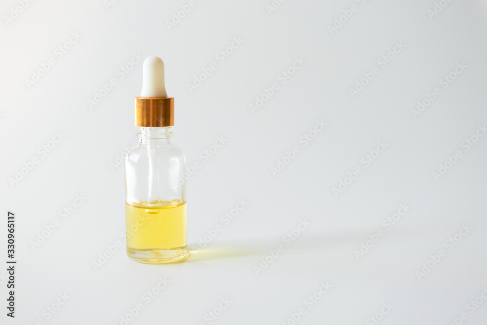Oil vitamin serum in glass bottle on light background, copy space. Skincare beauty product Oil vitamin serum in glass bottle on light background, copy space. Skincare beauty product