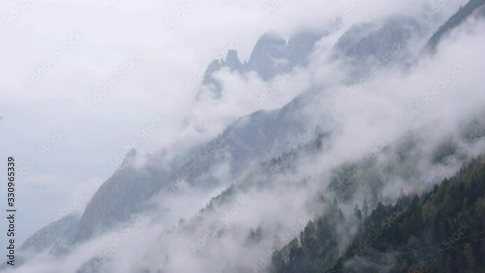 Mystic cloudy and foggy autumn alpine mountain slopes scene. Austrian Lienzer Dolomiten Alps. Peaceful picturesque traveling, seasonal, nature and countryside beauty concept scene. Mystic cloudy and foggy autumn alpine mountain slopes scene. Austrian Lienzer Dolomiten Alps. Peaceful picturesque traveling, seasonal, nature and countryside beauty concept scene.