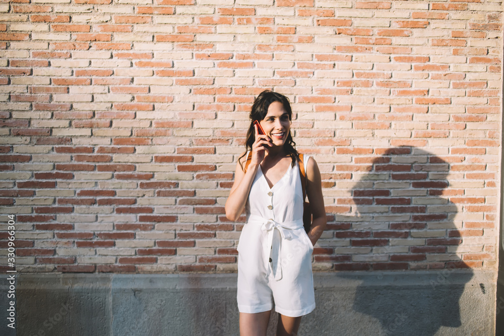 Young woman speaking on cellphone and smiling away Young woman speaking on cellphone and smiling away