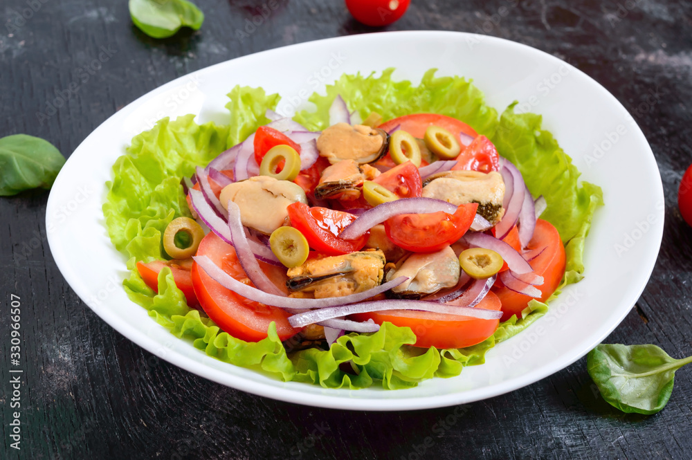 Salad of marinated mussels, fresh tomatoes, red onions, olives in a bowl on a black background Salad of marinated mussels, fresh tomatoes, red onions, olives in a bowl on a black background