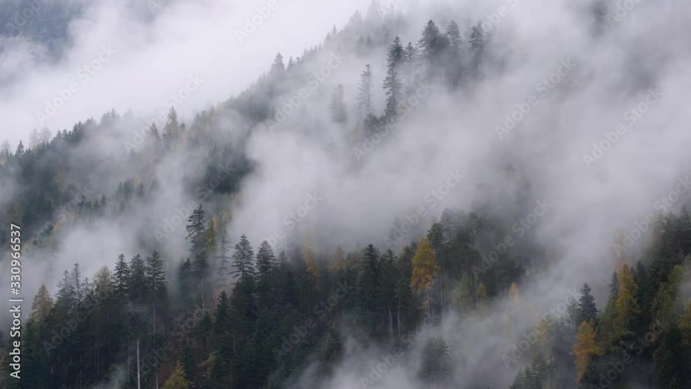 Mystic cloudy and foggy autumn alpine mountain slopes scene. Austrian Lienzer Dolomiten Alps. Peaceful picturesque traveling, seasonal, nature and countryside beauty concept scene. Mystic cloudy and foggy autumn alpine mountain slopes scene. Austrian Lienzer Dolomiten Alps. Peaceful picturesque traveling, seasonal, nature and countryside beauty concept scene.