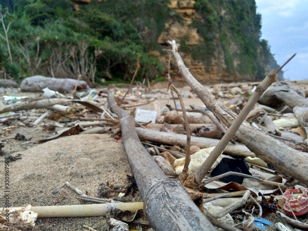 Rubbish in the beach make looks dirty and messy. the pollution because many plastic, wood and others waste. Rubbish in the beach make looks dirty and messy. the pollution because many plastic, wood and others waste.
