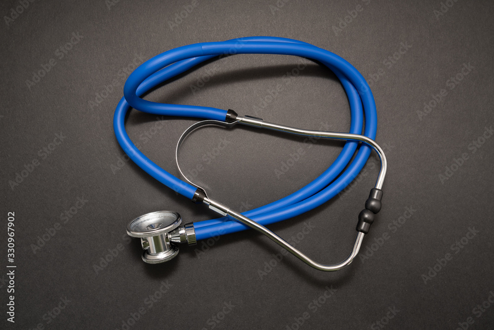 Stethoscope on black background, top view. Medical instrument Stethoscope on black background, top view. Medical instrument