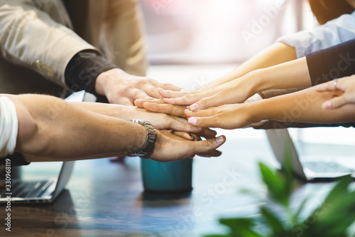 Close up business people connect joining hands together, Stack of hands, Teamwork partner concept.