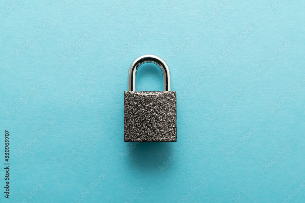 Naklejka premium Metal lock isolated on blue background.