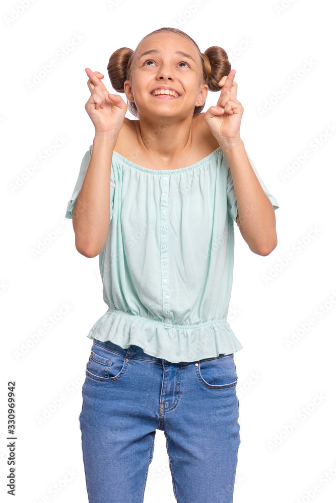 Portrait of teen girl crossing her fingers and wishing for good luck, isolated on white background. Caucasian teenager praying with crossed fingers, looking up. Child face expression emotions. Portrait of teen girl crossing her fingers and wishing for good luck, isolated on white background. Caucasian teenager praying with crossed fingers, looking up. Child face expression emotions.