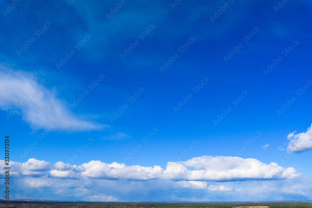 white storm clouds on a dark blue sky on a clear day. space for text. background image