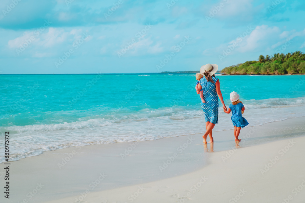 family on beach vacation-mother with two kids at sea family on beach vacation-mother with two kids at sea