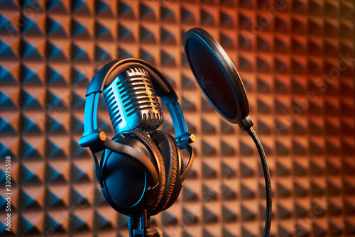 Retro microphone and pop filter on acoustic foam panel background