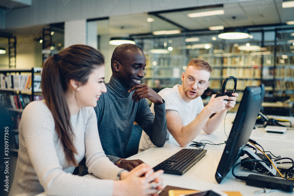 Students discussing ideas at library computer