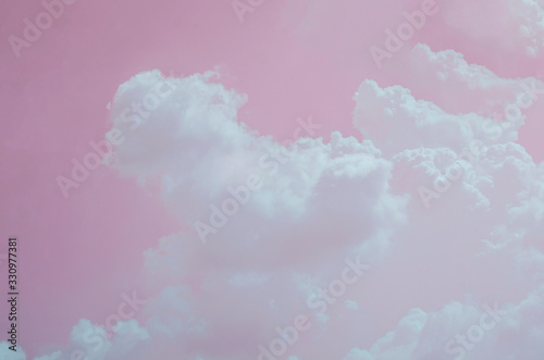 Pink sky with white clouds and blurred pattern background