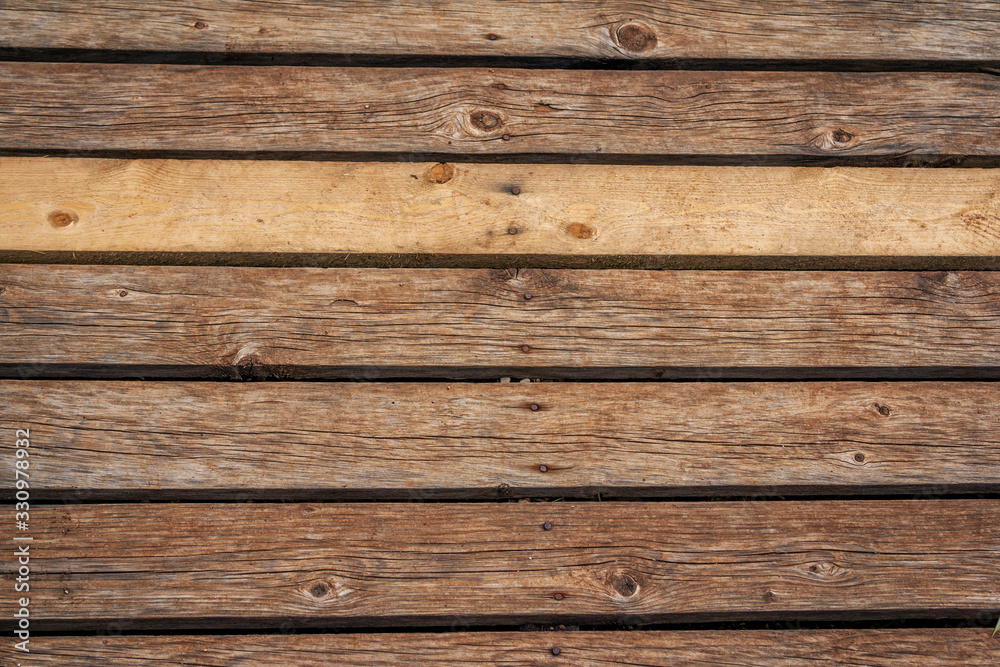 Old weathered wooden planks background. Abstract horizontal textured brown panels. Old weathered wooden planks background. Abstract horizontal textured brown panels.