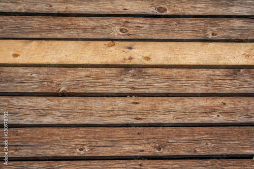 Old weathered wooden planks background. Abstract horizontal textured brown panels. 