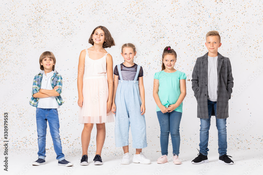 Group of happy children is standing together in a room Group of happy children is standing together in a room